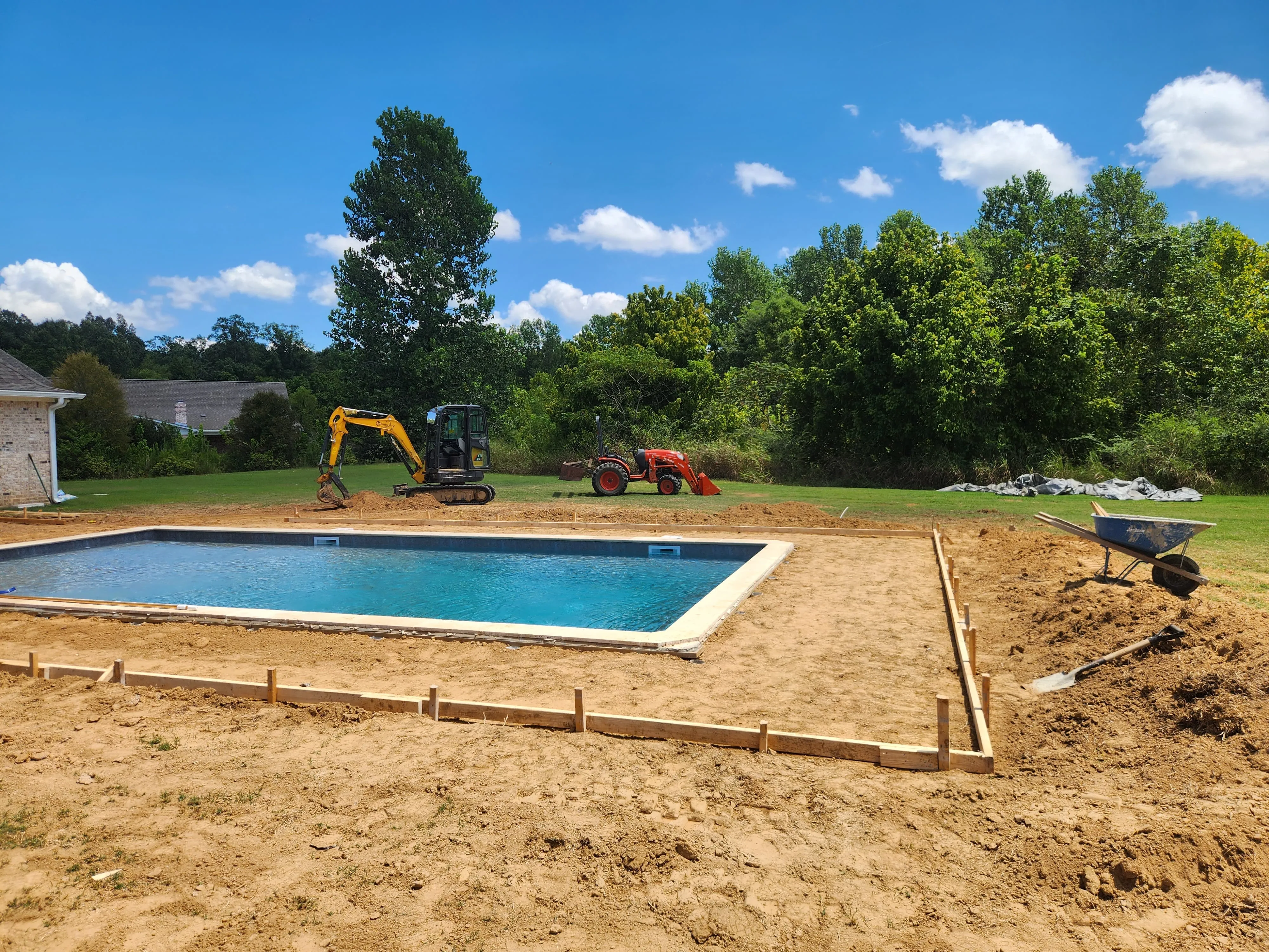 Pool excavation with equipment on site, Pearl, MS