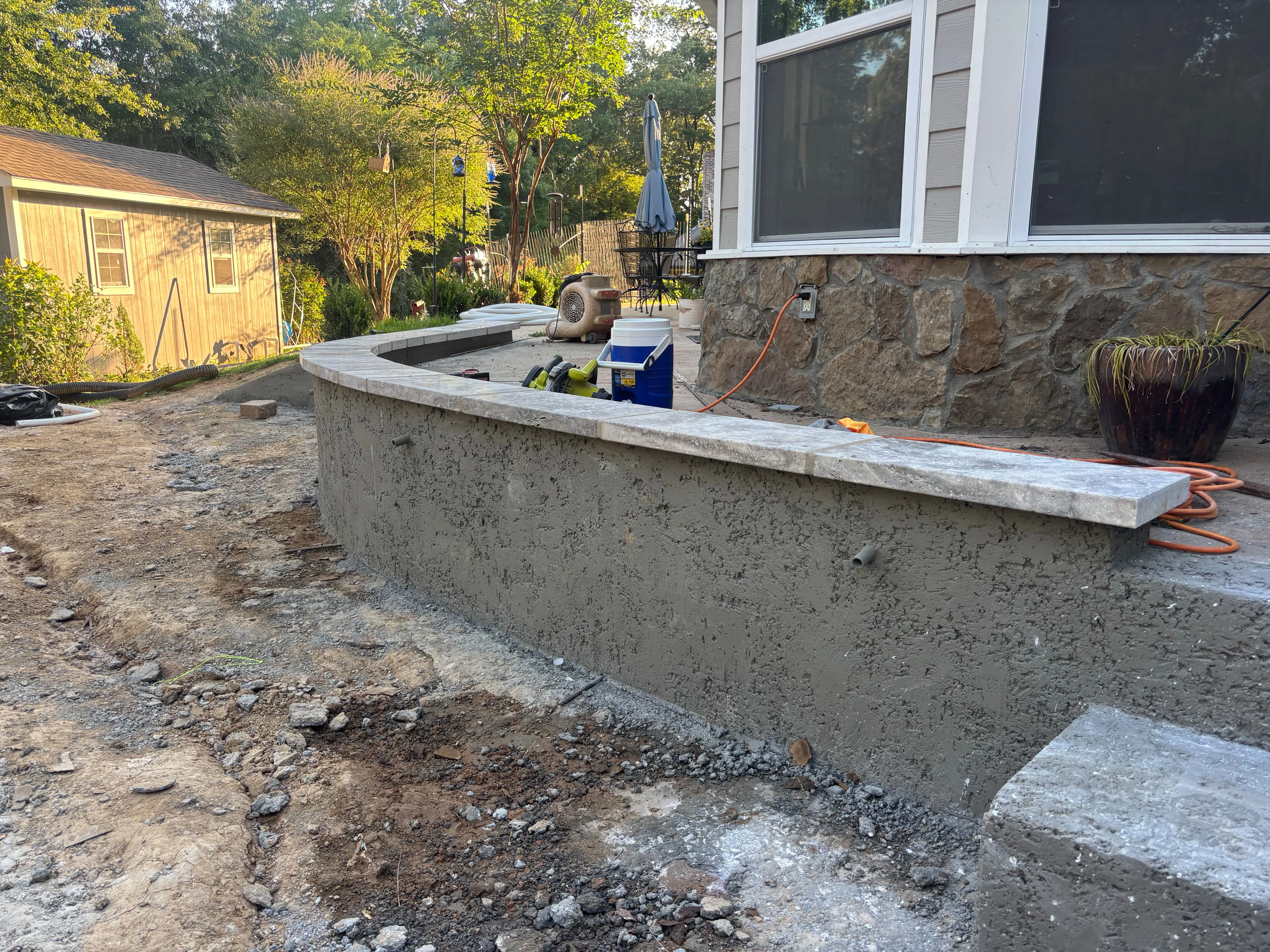 Curved concrete seat wall with stone cap, Pearl, MS