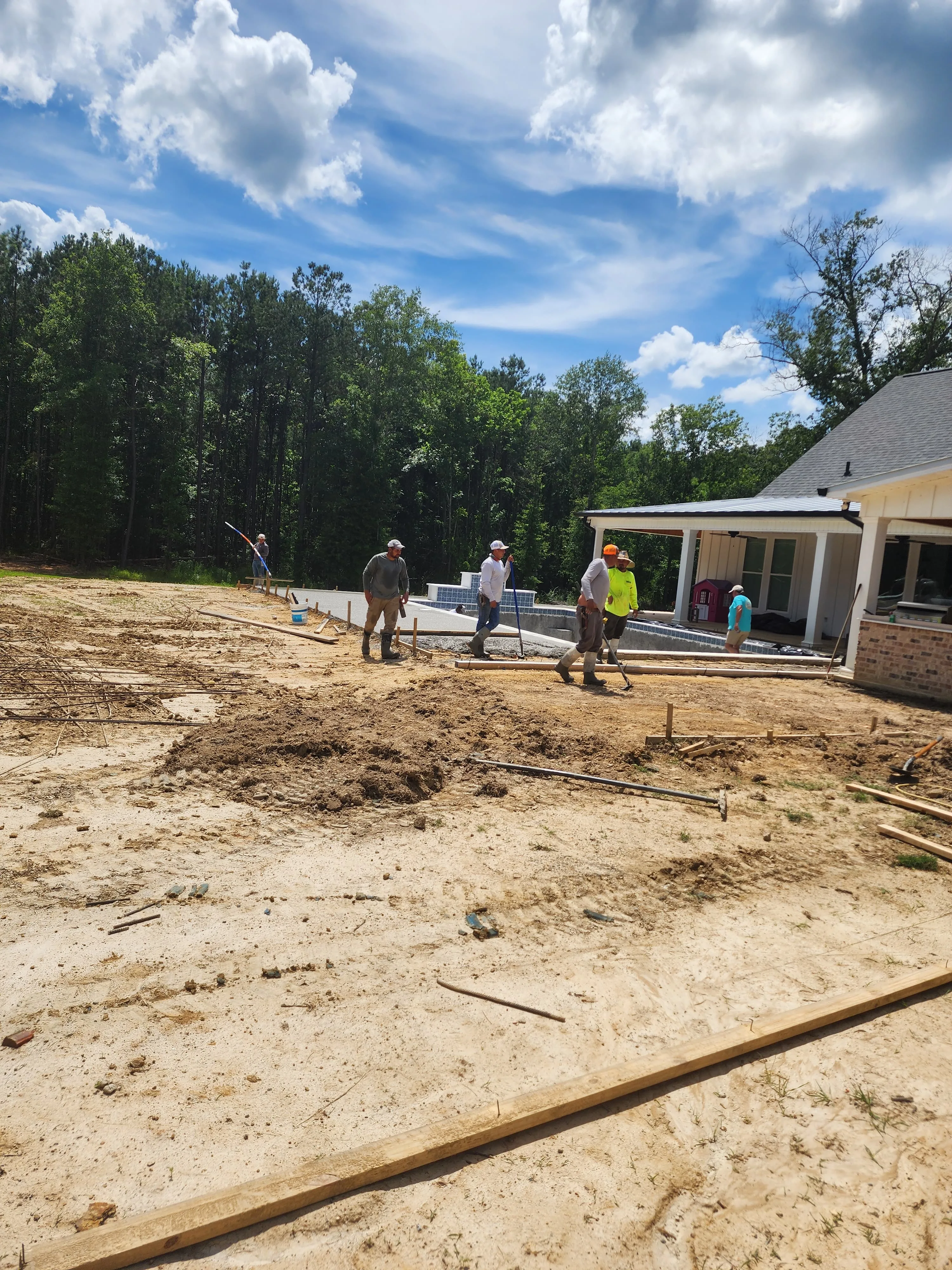 Crew and concrete mixer truck pouring a large slab, Pearl, MS